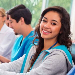 Student smiling with other students in background